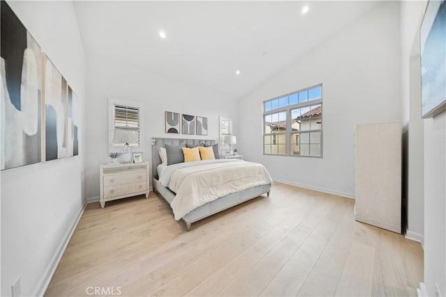 bedroom featuring light hardwood / wood-style flooring and high vaulted ceiling