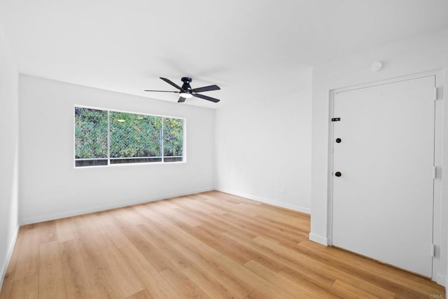 spare room featuring light hardwood / wood-style flooring and ceiling fan