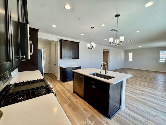 30750 Gazing Star Ln, Murrieta, CA 92563 - kitchen with a chandelier, stainless steel appliances, recessed lighting, light wood-style floors, and light countertops