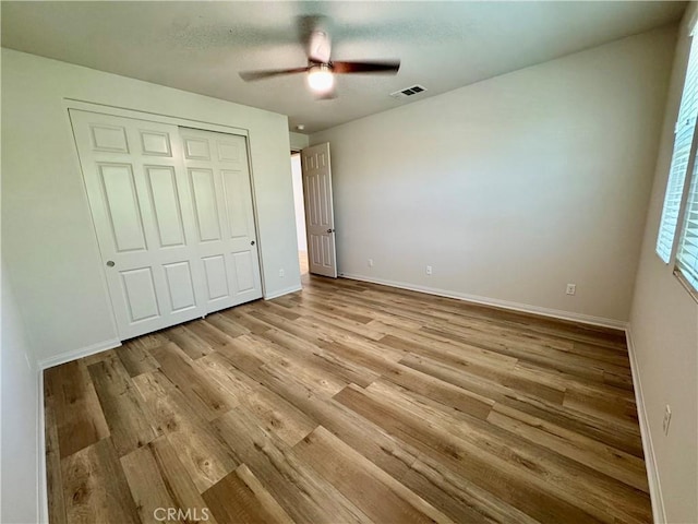 30750 Gazing Star Ln, Murrieta, CA 92563 - unfurnished bedroom with light wood-type flooring, a closet, and a ceiling fan