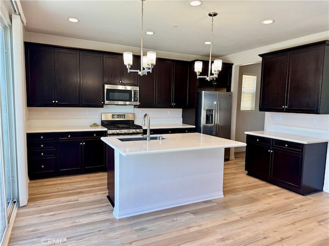 30750 Gazing Star Ln, Murrieta, CA 92563 - kitchen featuring stainless steel appliances, a chandelier, light wood-style floors, hanging light fixtures, and recessed lighting