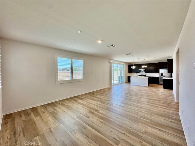 30750 Gazing Star Ln, Murrieta, CA 92563 - unfurnished living room with light wood-type flooring and recessed lighting