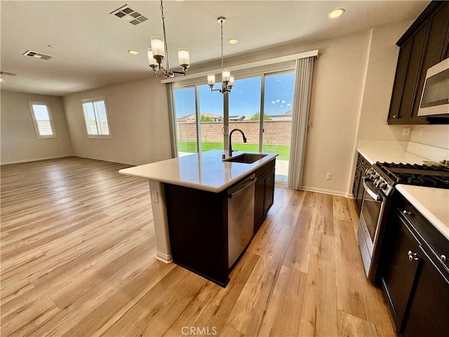 30750 Gazing Star Ln, Murrieta, CA 92563 - kitchen featuring appliances with stainless steel finishes, light wood-type flooring, a chandelier, light countertops, and recessed lighting