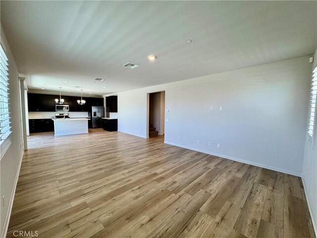 30750 Gazing Star Ln, Murrieta, CA 92563 - unfurnished living room featuring light wood-style flooring, recessed lighting, and plenty of natural light