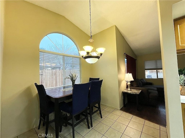 44009 17th St E, Lancaster, CA 93535 - dining space featuring light tile patterned floors, vaulted ceiling, and an inviting chandelier