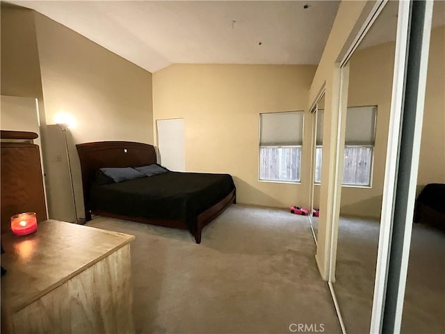 carpeted bedroom featuring lofted ceiling