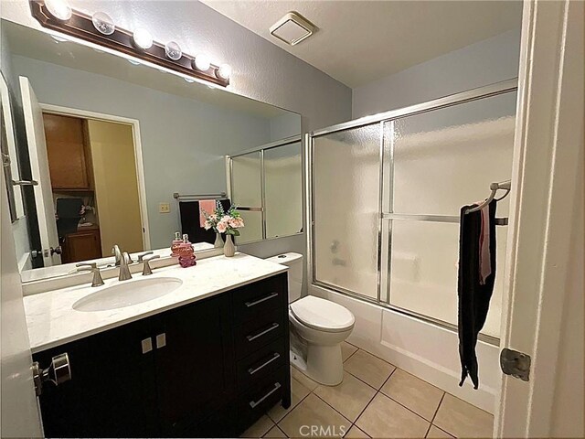 44009 17th St E, Lancaster, CA 93535 - full bath featuring tile patterned floors, bath / shower combo with glass door, vanity, and toilet