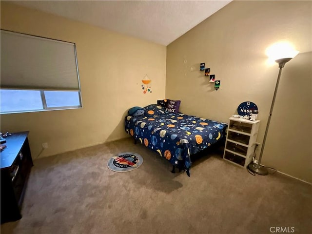 carpeted bedroom with lofted ceiling