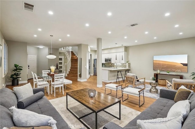 living room featuring light hardwood / wood-style flooring and sink