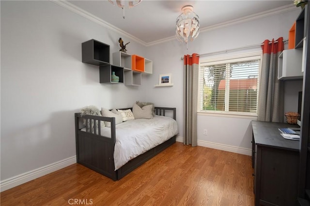 bedroom with ornamental molding and wood-type flooring