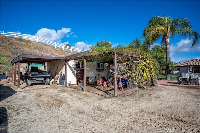 back of property with a carport