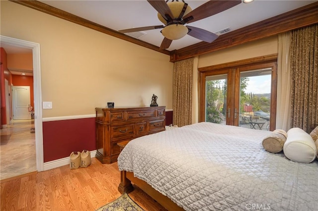 bedroom with crown molding, light hardwood / wood-style flooring, ceiling fan, access to outside, and french doors