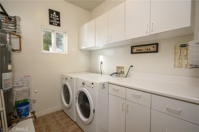 laundry area featuring cabinets, separate washer and dryer, and light tile patterned floors