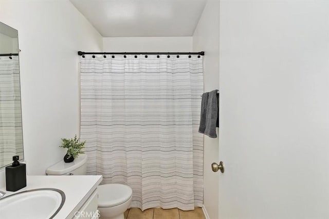 bathroom featuring vanity, toilet, and tile patterned floors