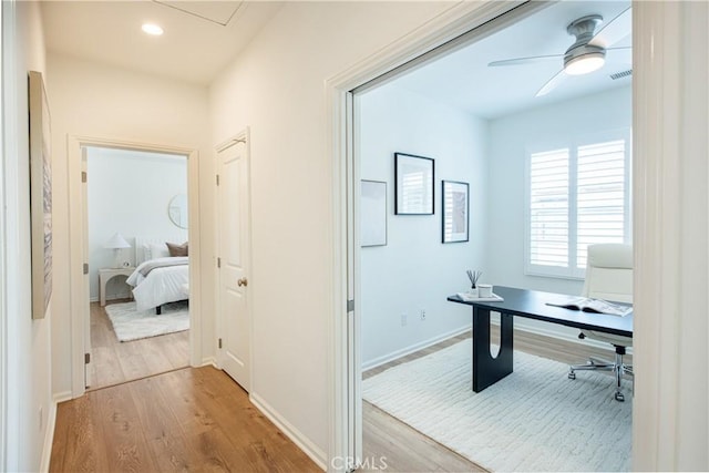 office featuring light hardwood / wood-style floors and ceiling fan