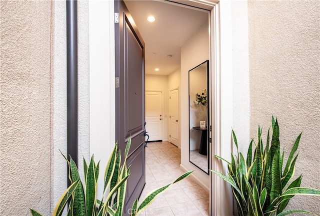 hall featuring light tile patterned floors