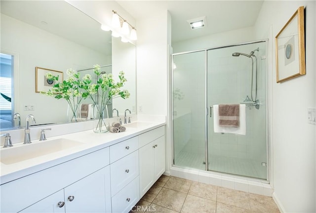 bathroom with vanity, tile patterned flooring, and a shower with shower door