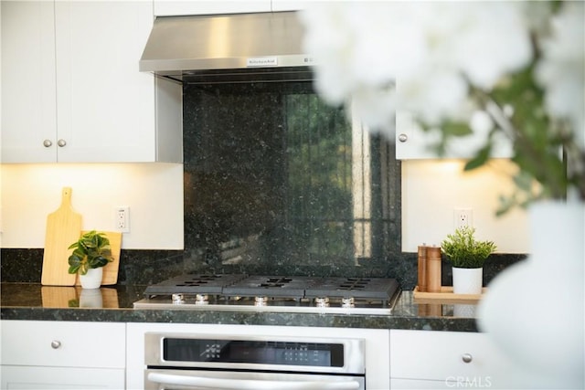 kitchen featuring white cabinetry, appliances with stainless steel finishes, and range hood