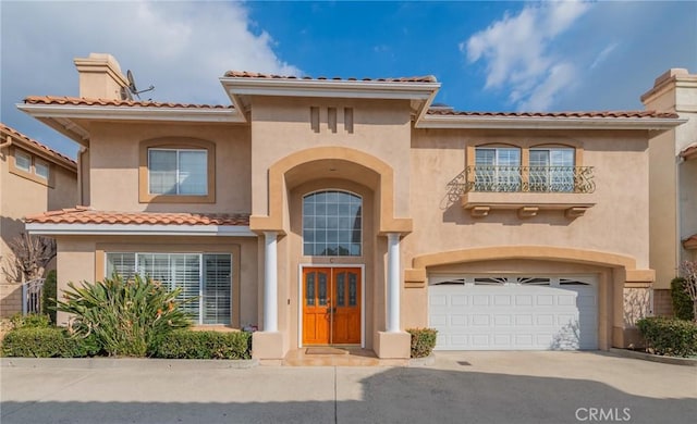 mediterranean / spanish-style home with a garage