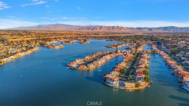 birds eye view of property with a water and mountain view