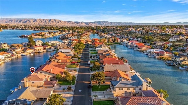 drone / aerial view with a water and mountain view