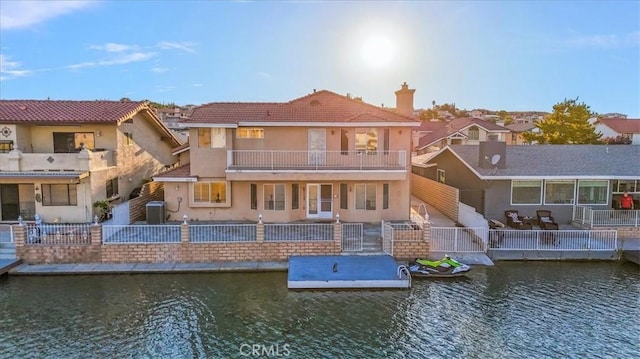 rear view of house with a water view and a patio area