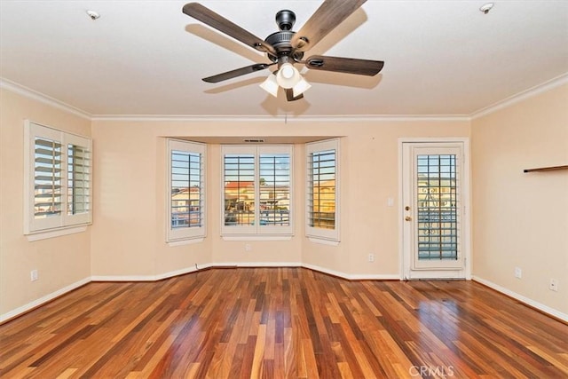 spare room with crown molding, ceiling fan, and wood-type flooring