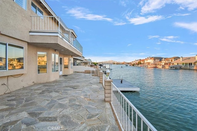 exterior space featuring a boat dock and a water view