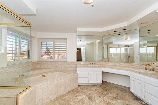 bathroom featuring vanity and shower with separate bathtub