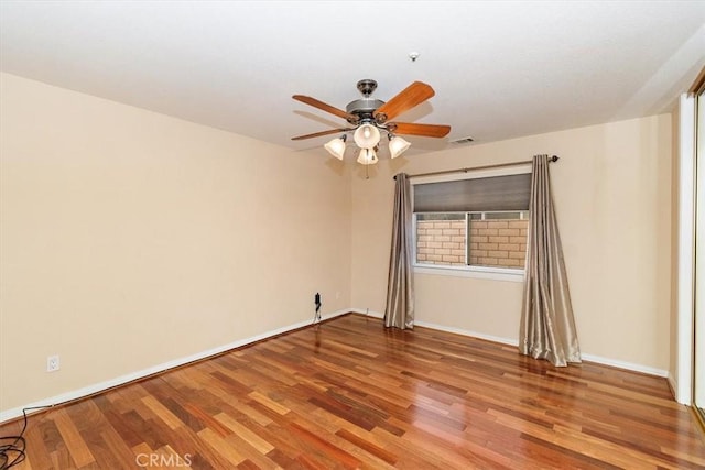 empty room featuring hardwood / wood-style floors and ceiling fan