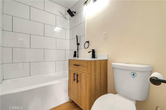 full bathroom featuring toilet, vanity, and tiled shower / bath