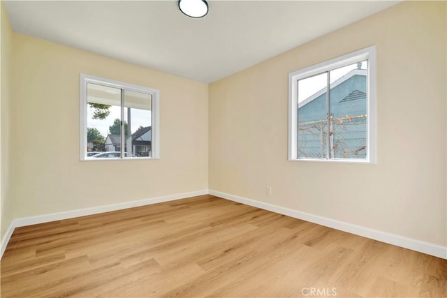 spare room featuring light hardwood / wood-style flooring