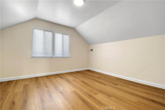 bonus room with light hardwood / wood-style floors and lofted ceiling