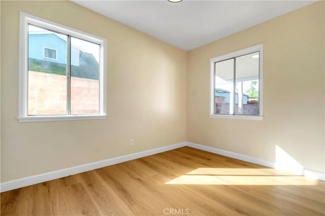 spare room with light hardwood / wood-style flooring