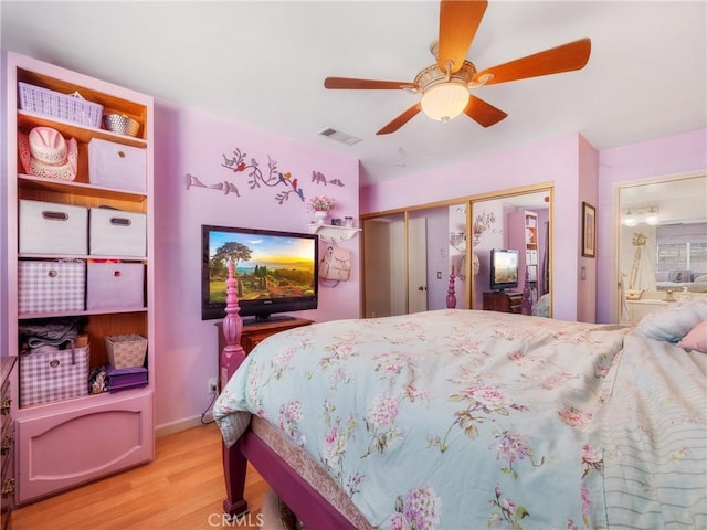 27767 Hummingbird Ln, Helendale, CA 92342 - bedroom with light wood-type flooring, ceiling fan, a closet, and connected bathroom