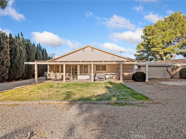 27767 Hummingbird Ln, Helendale, CA 92342 - rear view of house with a patio, a lawn, and stucco siding