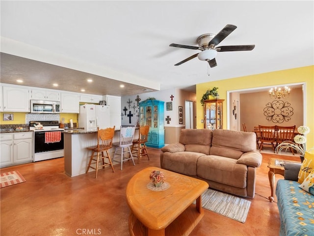 27767 Hummingbird Ln, Helendale, CA 92342 - living area with concrete floors, recessed lighting, a ceiling fan, and a chandelier