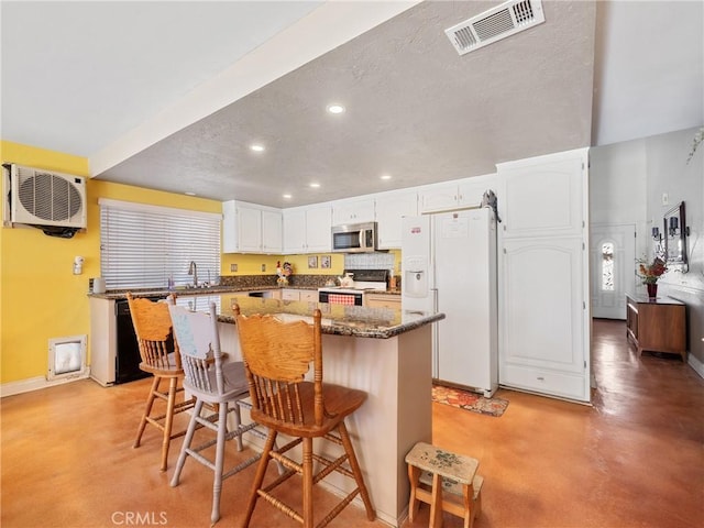 27767 Hummingbird Ln, Helendale, CA 92342 - kitchen featuring white fridge with ice dispenser, range with electric stovetop, concrete floors, stainless steel microwave, and recessed lighting