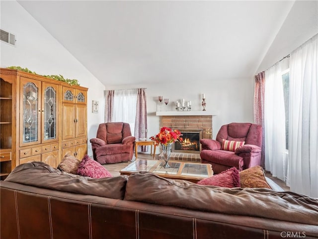27767 Hummingbird Ln, Helendale, CA 92342 - living area featuring lofted ceiling and a fireplace