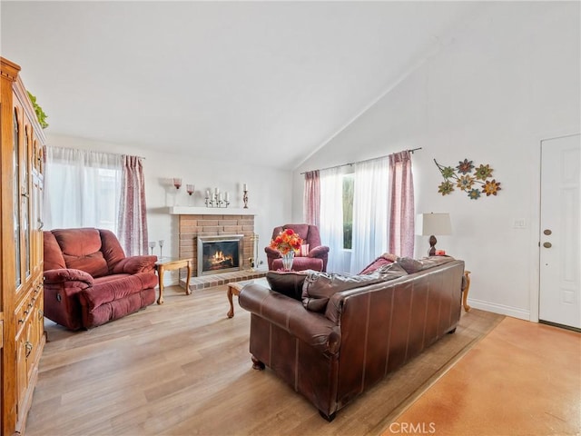 27767 Hummingbird Ln, Helendale, CA 92342 - living area with high vaulted ceiling, a brick fireplace, and light wood-style flooring