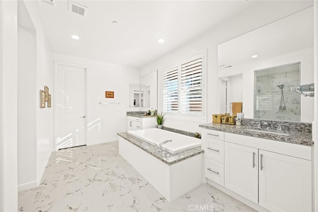 bathroom with vanity and separate shower and tub