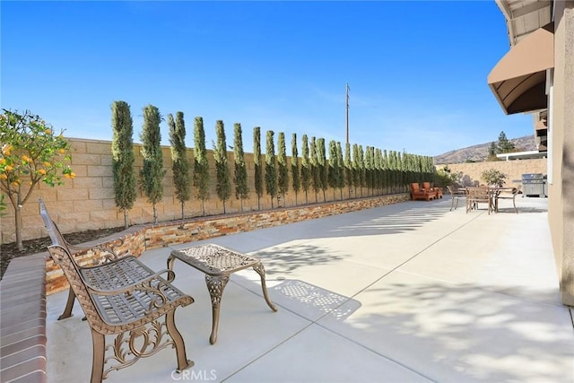 view of patio / terrace with a mountain view