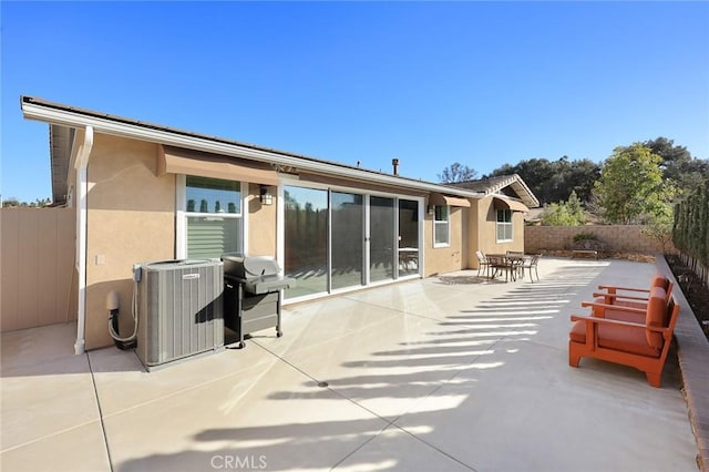 back of house with a patio area and central air condition unit