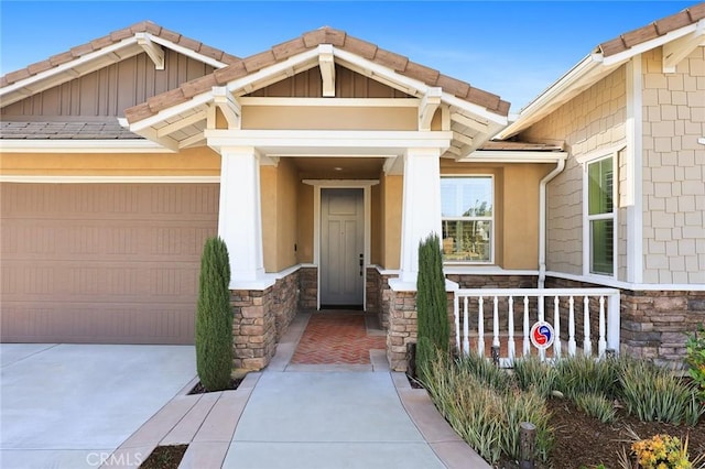 property entrance with a garage and a porch