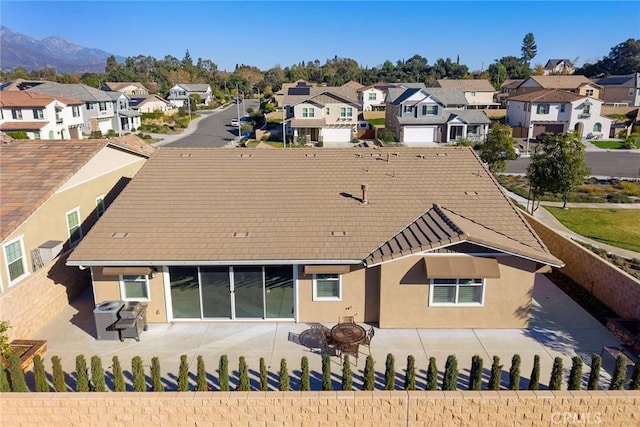 rear view of property with a patio and a mountain view