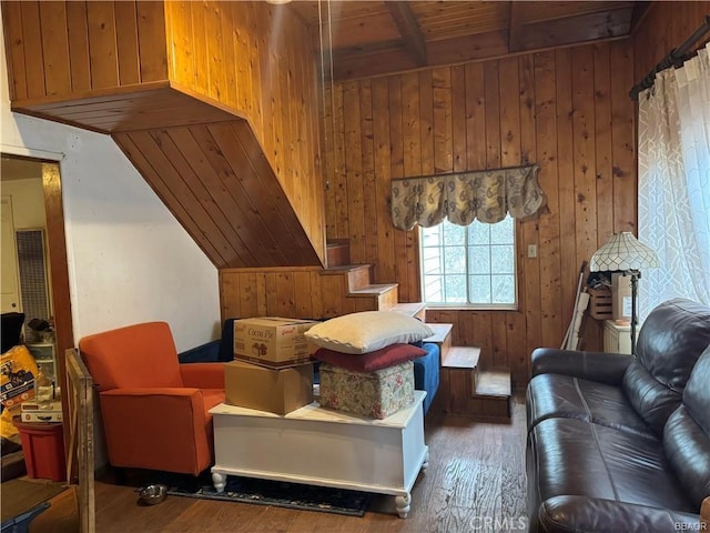 living room with beamed ceiling, dark hardwood / wood-style floors, wooden walls, and wooden ceiling