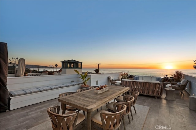 view of patio featuring a water view, an outdoor hangout area, and outdoor dining space