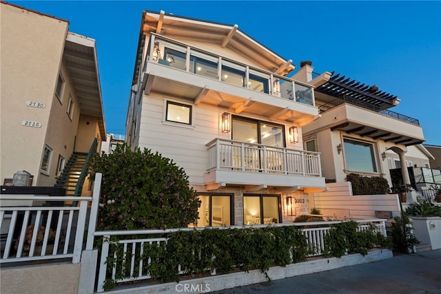 view of front of home featuring a fenced front yard and a balcony