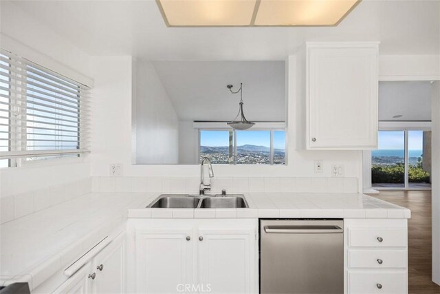 31232 Palma Dr, Laguna Niguel, CA 92677 - kitchen featuring stainless steel dishwasher, tile countertops, and white cabinets