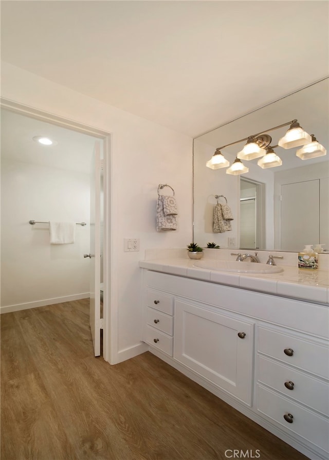 31232 Palma Dr, Laguna Niguel, CA 92677 - bathroom featuring vanity, wood finished floors, and baseboards